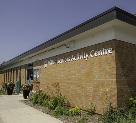 A building with the words Milton Seniors Activity Centre on it with blue sky behind