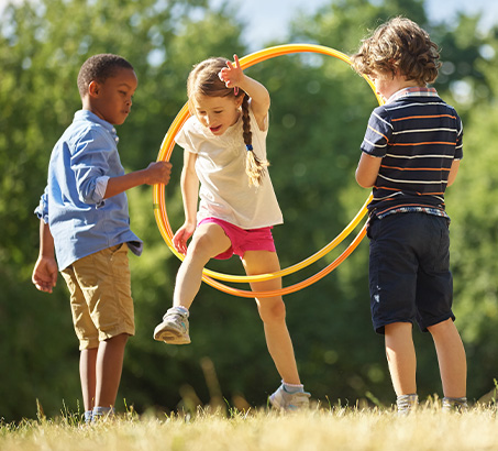 Three children playing outside