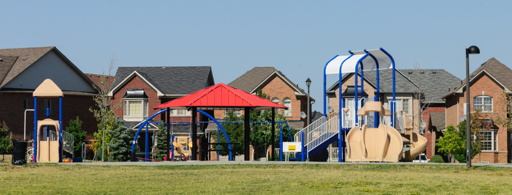 A neighbourhood park situated in front of a row of houses in Milton