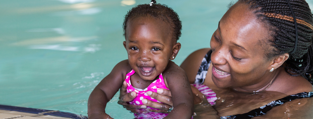 mom and baby taking swim lessons at the local pool