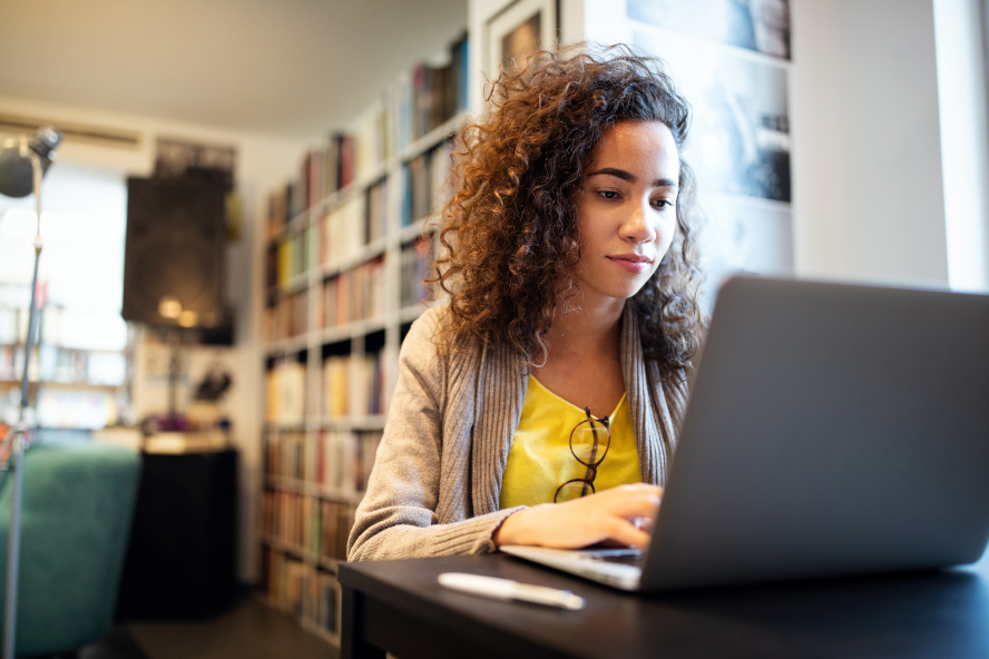 A young person on a laptop at home