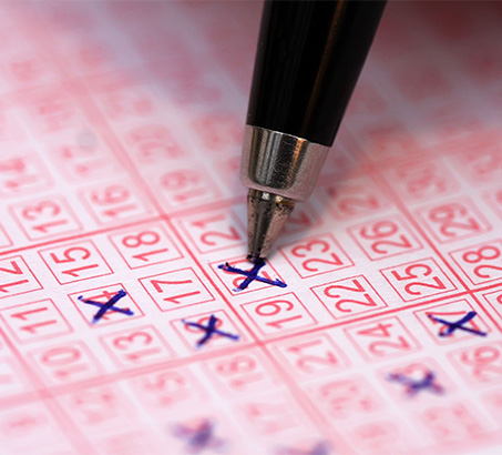 A pen making marks on a lottery ticket