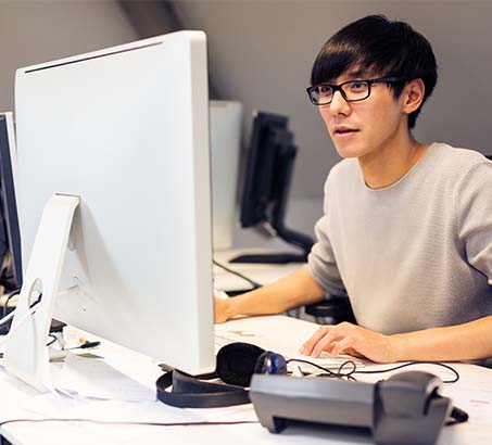 Young man sitting at a computer working