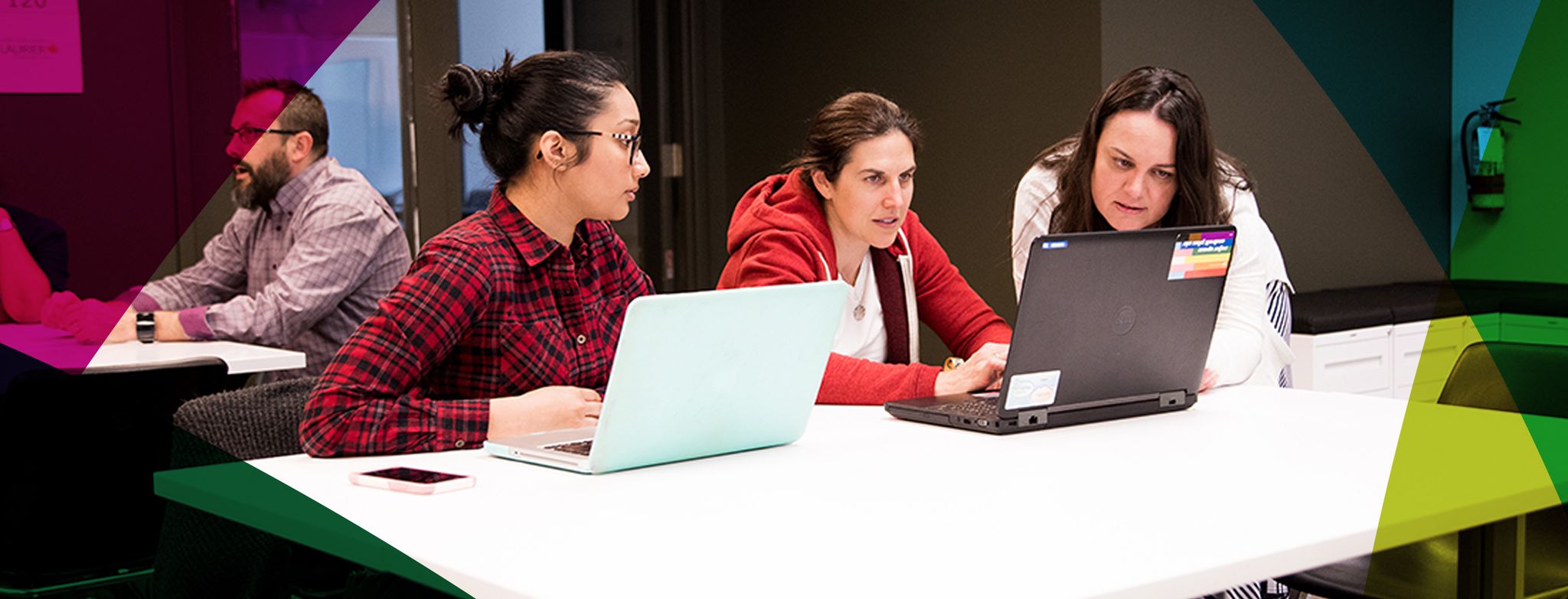 Picture of students around a laptop communicating