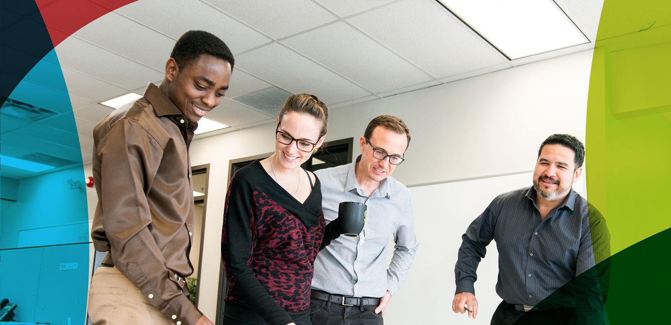 Professionals standing around a table 