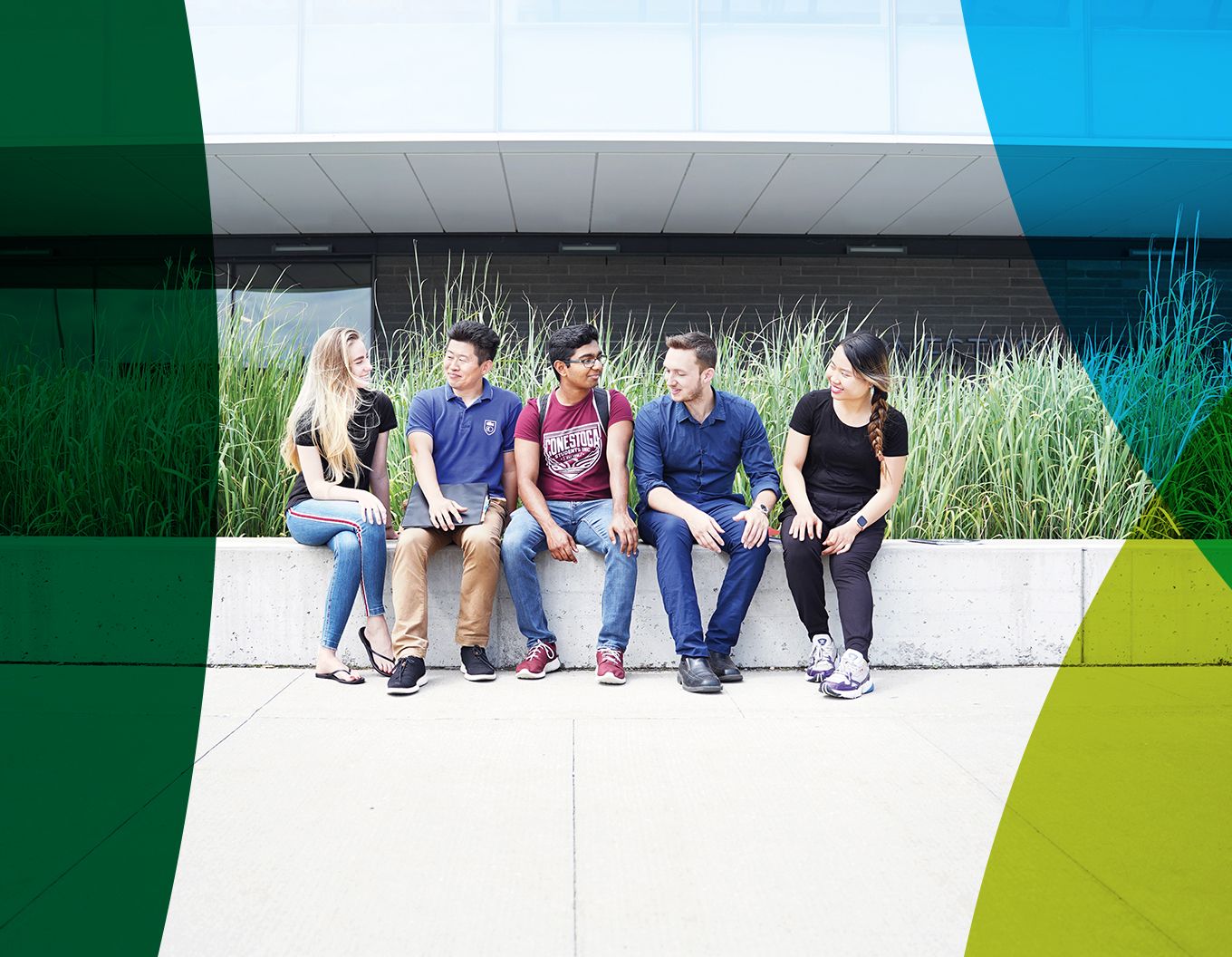 Students sitting outside side by side