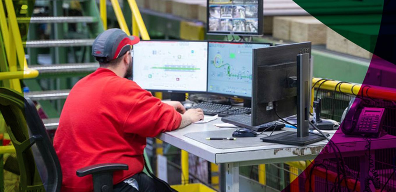 Picture of a man working in front of a computer screen