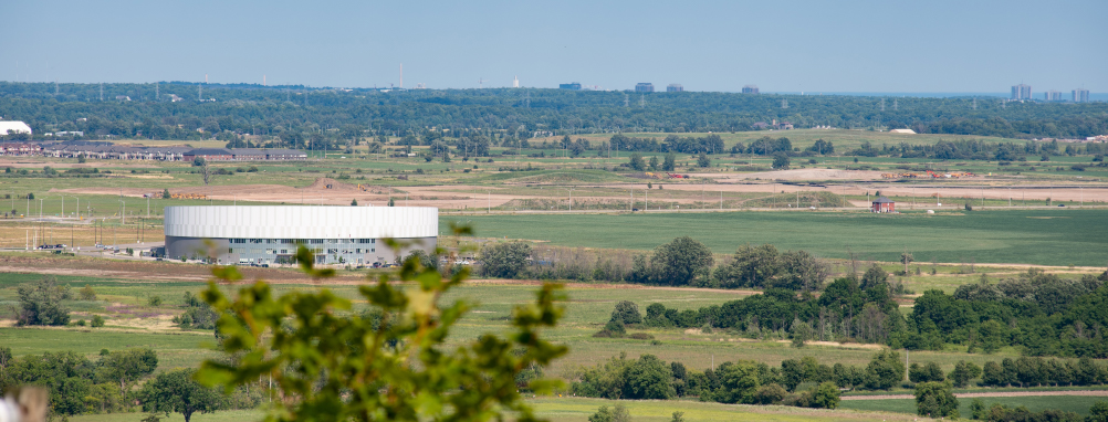 Mattamy National Cycling Centre with green fields and trees on either side