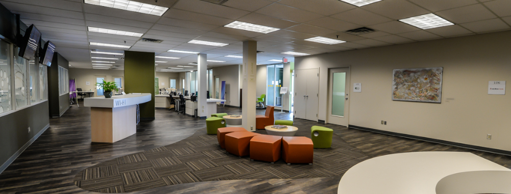 The inside of the MEV Innovation Centre featuring seating, a desk and TV screens
