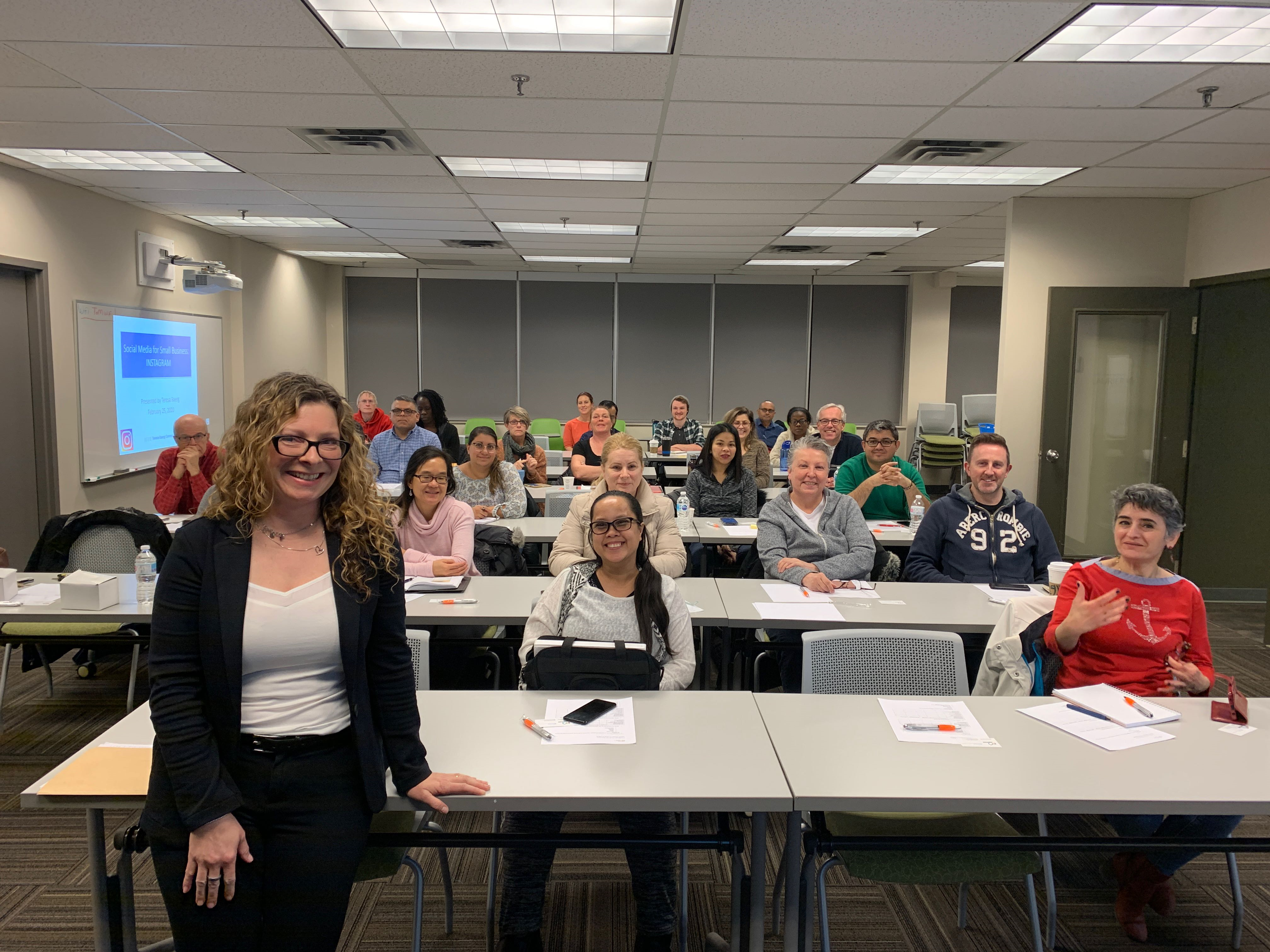 A room full of people with desks and chairs 