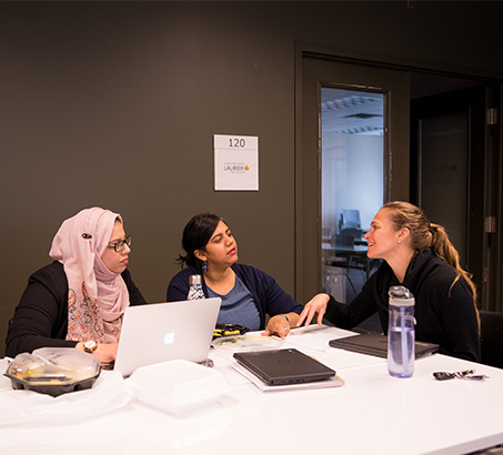 Three woman sitting at a table talking