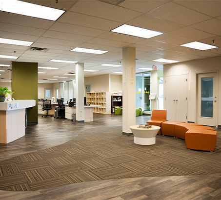Large room with desks, couches, tables and chairs