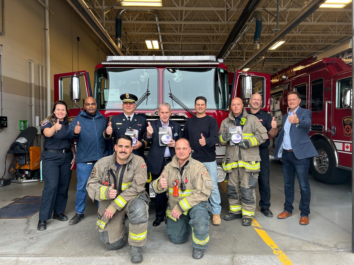 A photo of fire fighters in front of a fire truck