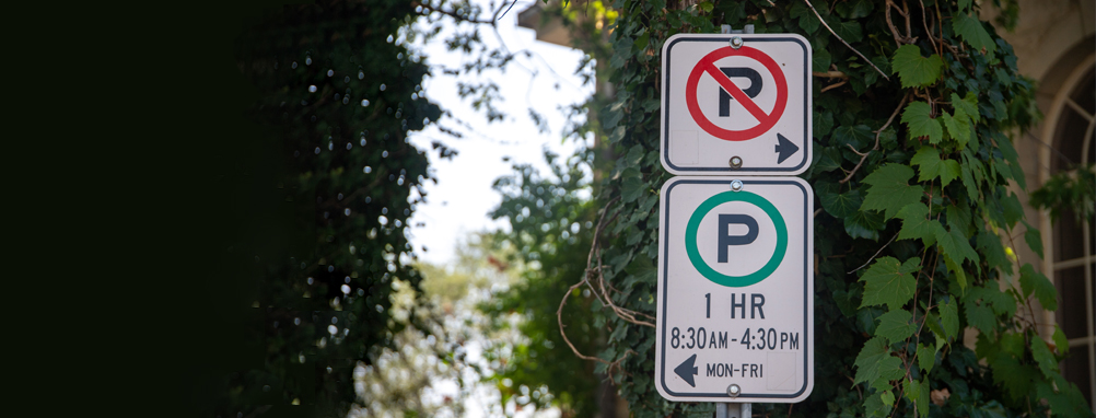 Parking and no parking signs on a street in Milton.