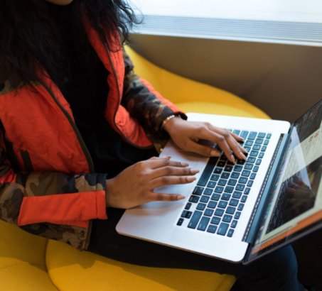 A woman sitting at a desk with a laptop