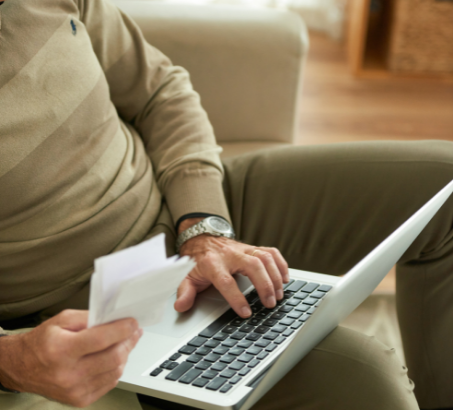 A man sitting in a chair with a laptop