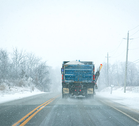 A snow plow clearing a road
