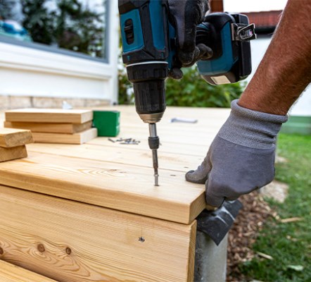 A drill on a wood deck