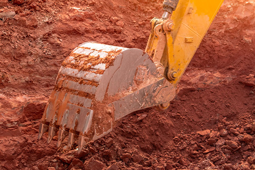 A back hoe digging dirt