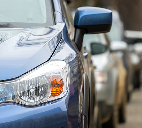 Cars parked in a line up the street