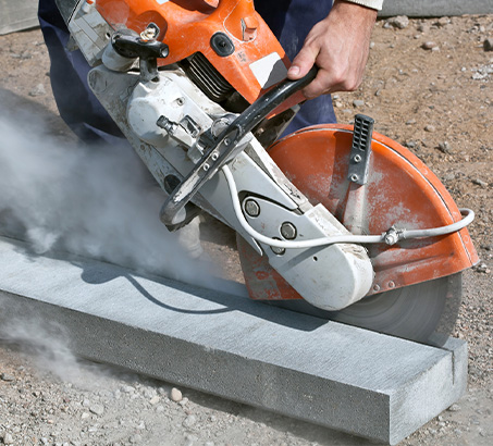 A person cutting a street curb