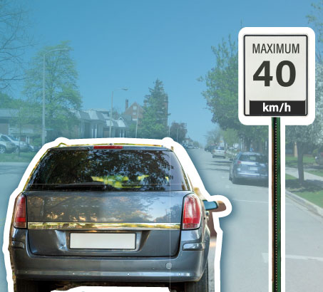 An SUV driving by a speed limit sign