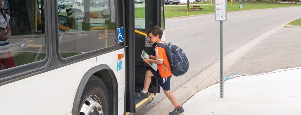 Boy boarding bus