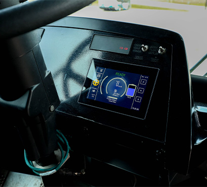 An electric bus steering wheel and display screen showing battery life