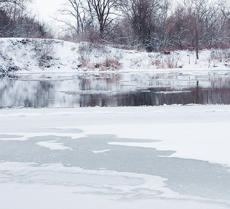 Thin ice on a pond with open water nearby