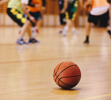 A basketball with players in the background