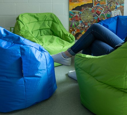 A person seated in a bean bag chair