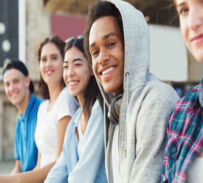 Four youth sitting in front of store 