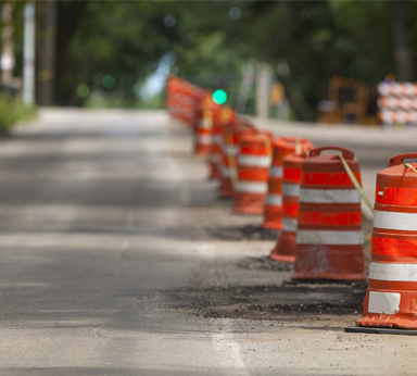 A road with construction plyons in a line