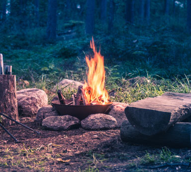 A campfire burning in a rock firepit