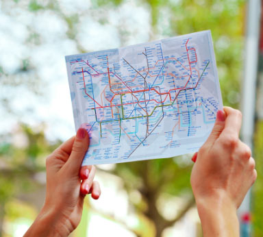 Hands holding a transit map up