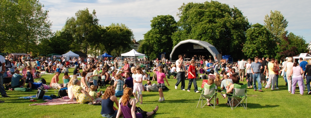 People at a music festival outside in a grassland