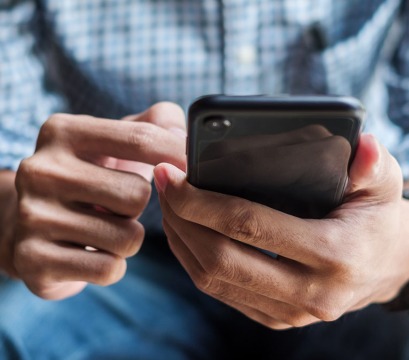 Hands holding a cell phone