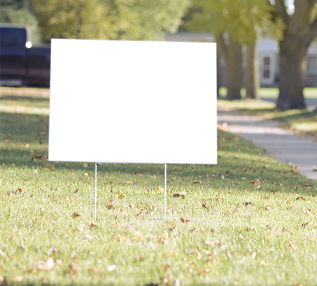 Blank lawn sign on a front lawn