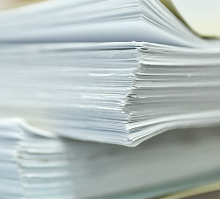 A stack of papers on a desk