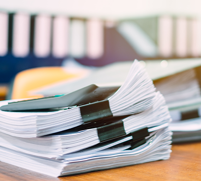 A pile of papers on a desk